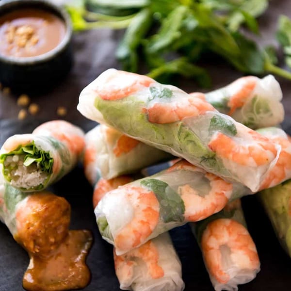 Fresh Vietnamese spring rolls with shrimp, lettuce, and herbs, served with peanut dipping sauce.